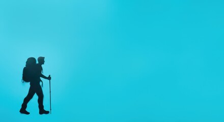 Obraz premium Person hiking with trekking poles in vast blue environment