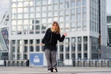 Dancer performs contemporary routine in urban setting during late afternoon