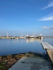 Fototapeta premium Skive yacht harbor in Skive, Denmark, Europe. Harbor with Wooden Pier and Sailing Ships. Beautiful view. Boats moored in Maarup Havn, Samsoe, Jutland, Denmark. Beauty in nature. Sailboats in harbor