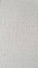 Fototapeta premium Close-up shot of a textured canvas background with a rough and grainy surface, ideal for adding depth and dimension to design projects, close-up, material