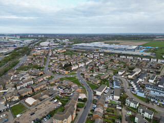 Fototapeta premium High Angle View of Tilbury City Centre and Docks on River Thames, borough of Thurrock, Essex, England, United Kingdom. Aerial View Was Captured with Drone's Camera on April 20th, 2024 at Just After Su