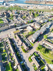 Fototapeta premium High Angle View of Tilbury City Centre and Docks on River Thames, borough of Thurrock, Essex, England, United Kingdom. Aerial View Was Captured with Drone's Camera on April 20th, 2024 at Just After Su