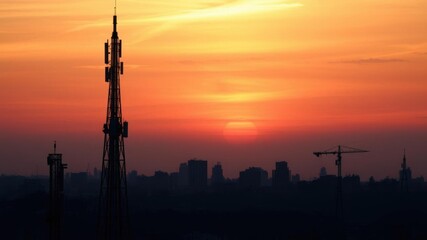 Obraz premium Telecom tower silhouette against colorful sky at dusk, technology, background