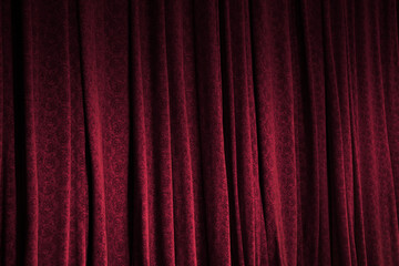 Elegant red curtains in theatre as background, closeup
