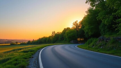 A beautiful landscape of a winding road leading towards the sunrise, with lush green trees lining the path, adventure, sunrise