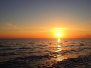 Fototapeta premium Vibrant sunrise over a calm ocean, with golden hues reflecting off the water, tranquil, golden hues