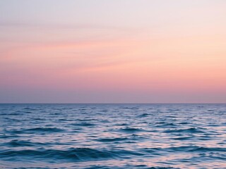 Fototapeta premium A peaceful ocean horizon at sunset, with soft pastel colors reflecting on the water, landscape, reflection