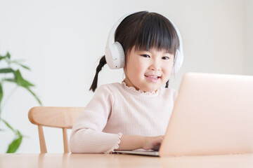パソコンでオンラインレッスンを授業を受ける子供