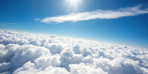 Fototapeta premium A stunning aerial view of fluffy white clouds from above, with the sun shining through, above, scenic