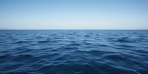 Obraz premium A serene ocean background with gentle waves and a clear blue sky, natural, calm