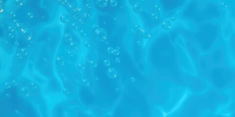 Obraz premium A close-up shot of bubbles floating on the surface of clear blue water, water, blue