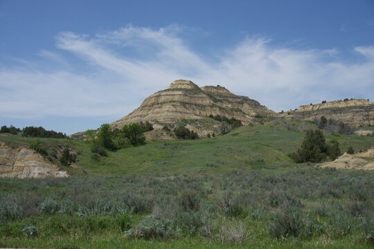 Theodore Roosevelt National Park Landscape with Grass, Blue Sky, and Mountains