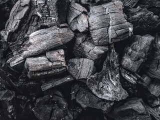 Black charcoal from burning wood. Charcoal is the result of burning wood and produces a black...