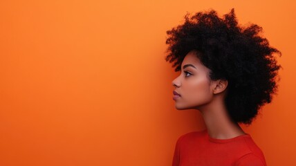 Profile of African American woman against orange background