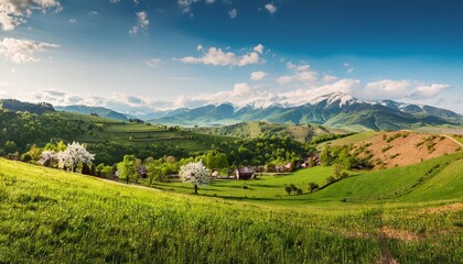 Obraz premium Mountain landscape with blue sky and green fields