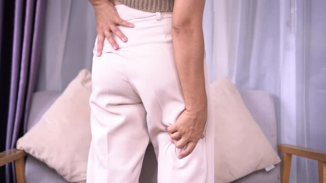 Sciatica concept with woman suffering from back pain spreading to legs