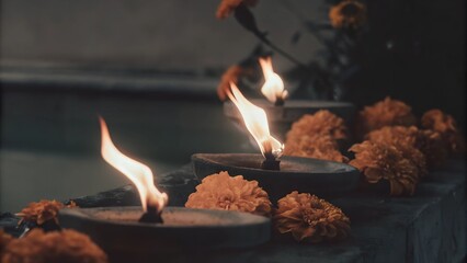 Traditional Oil Lamps with Flickering Flames Surrounded by Marigold Flowers, Perfect for Religious Ceremonies, Spiritual Gatherings, Festive Decor, or Cultural Photography