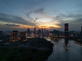 Sunset on Saigon River Waterfront, Ho Chi Minh City, Vietnam from dramatic aerial view. 