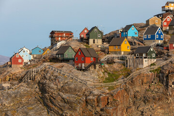Traditional wooden houses on a cliff, Uummannaq island, Greenland © PetraJPhoto
