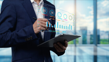 Business Professional Analyzing Data with Tablet in Modern Office Environment Featuring Digital Graphs and Statistics for Corporate Success and Analysis