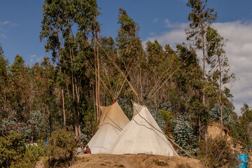 Community of people in a camp in the mountains of cusco peru on a vision quest with teepees 