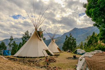 Community of people in a camp in the mountains of cusco peru on a vision quest with teepees 