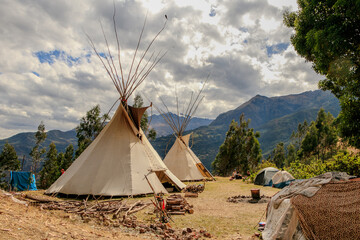 Community of people in a camp in the mountains of cusco peru on a vision quest with teepees 