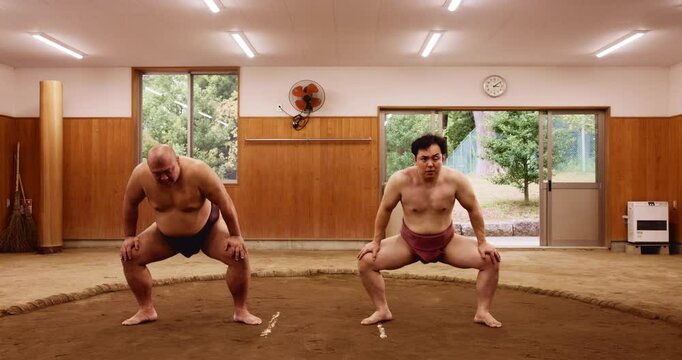 Stretching, sumo and training with Japanese people in arena for wrestling, shiko ritual and tournament. Festival, competition and game with asian men in dohyo ring of temple for culture and sports