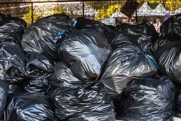 Stack of waste in black plastic bags 