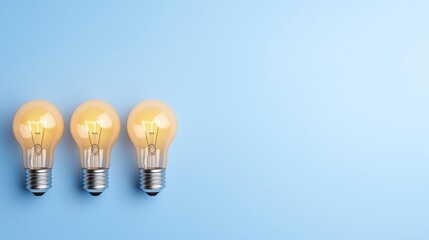 Three Vintage Light Bulbs on a Blue Background Ideal for Creative Projects, Interior Design, or Lightbulb Innovations in Modern Spaces