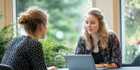 A mentor guiding a junior employee during a one on one coaching session