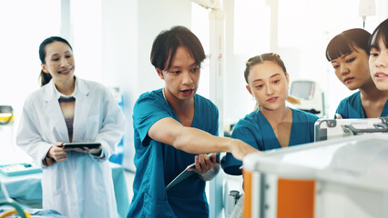 Doctor, students and machine for medical lecture, education or practical assignment in hospital....