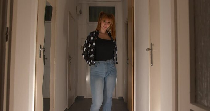 Sexy beautiful and creepy girl standing in the dark hallway showing a cleaver