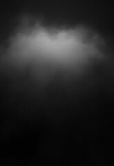 Minimalist black rectangular object on a dark surface with a matching background The black background has a spotlight shining down in the center, like a stage model. 