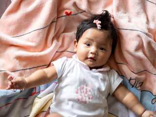 Newborn baby joyfully playing on soft blanket at home family bonding indoor warm cherishing early moments