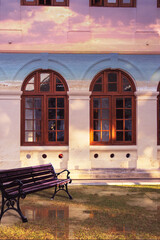 Charming and Beautiful Outdoor Setting Featuring a Vintage Bench Surrounded by Arched Windows