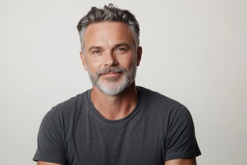 Obraz premium Happy middle aged 45 years old man isolated on white studio background. Confident mature handsome bearded gray haired
