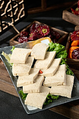 A plate of frozen tofu slices