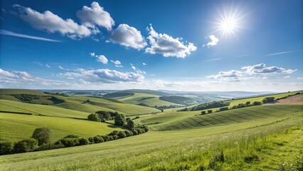 Obraz premium Rolling hills and vast meadow fields under a brilliant blue sky on a sunny day in the English countryside, sunshine, natural scenery
