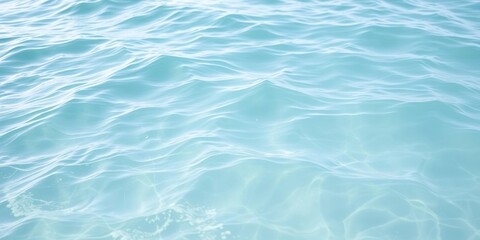 Obraz premium Soft light blue ocean waves gently lapping at the shore with a silky smooth texture and clear blue water, light blue ocean waves, clear blue water, gentle lapping