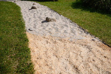 Barefoot path in public park. Tactile massage eco -path with different textures in nature for walking barefoot. Prevention of flat feet, strengthening immune system, contact with nature