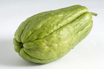 Single chayote cucumber showcasing unique texture and shape in bright light