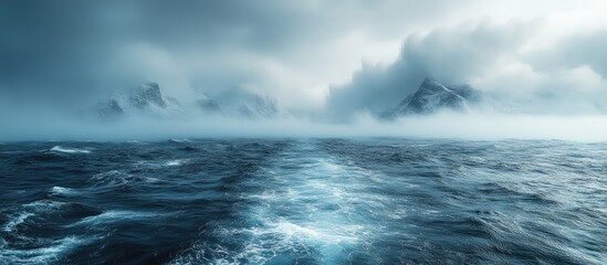 Fototapeta premium Mysterious foggy seascape blending with dramatic clouds and icy mountain peaks under extreme temperatures and atmospheric conditions