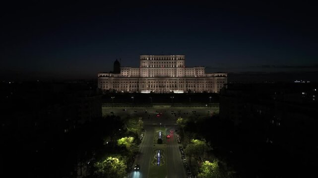 Romanian Parliament by night. Aerial 4k video with Palace of Parliament building lights on during the evening. Concept photo for Bucharest, Romania.