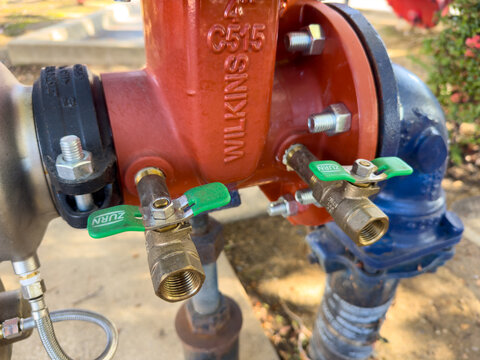 Close-up of valves on the fire sprinkler PIV backflow device by Wilkins company.