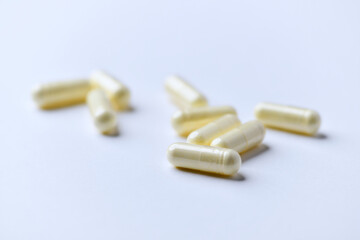 Alpha-lipoic acid capsules. Paper background. Soft focus. Close up. Copy space.