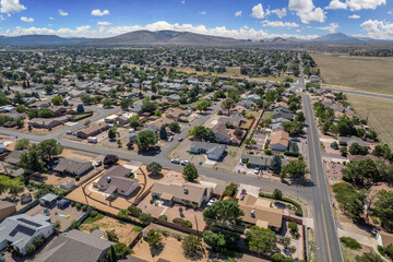 Aerial view of a suburban neighborhood with mountains in the background