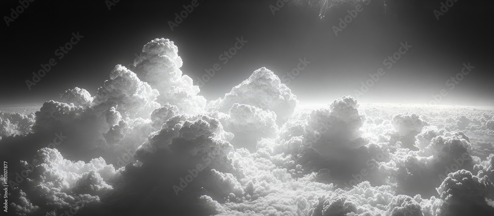 Poster dramatic monochrome aerial view of majestic clouds illuminated by sunlight creating a serene atmosph