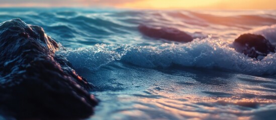 Fototapeta premium Ocean waves gently lapping against rugged rocks during a stunning sunset highlighting the beauty of nature's tranquility and movement
