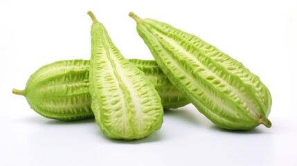 Fresh bitter melon fruits arranged elegantly on a clean white surface highlighting their unique texture and vibrant green color.